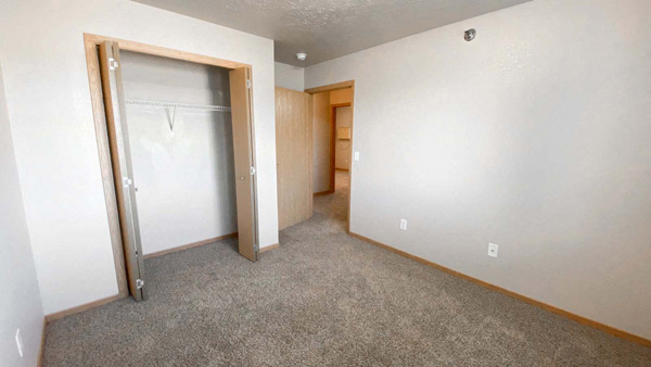 Full closet at Amber Valley in Fargo ND in a carpeted bedroom