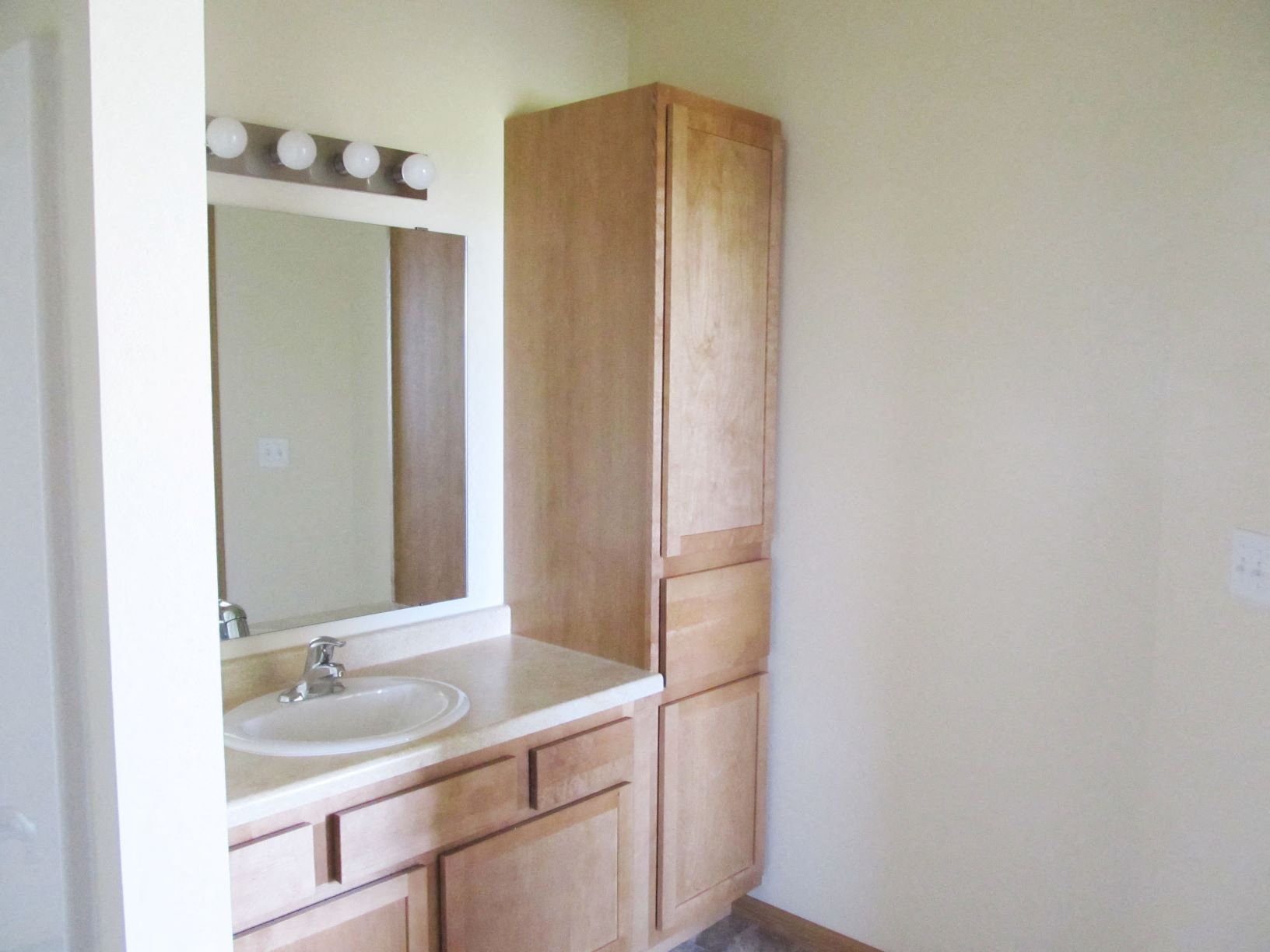 Large cupboard space and tile flooring in the bathroom at Brandtplace apartment homes in Fargo, North Dakota.