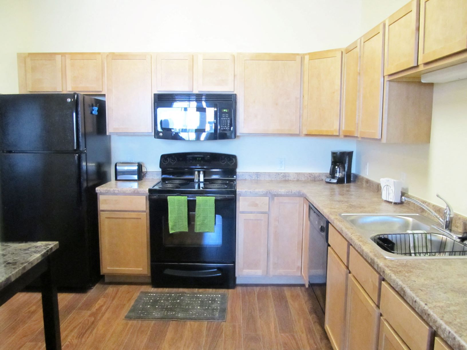 Furnished full kitchen with open unit layout and wood flooring at Brandtplace apartment homes in Fargo, ND