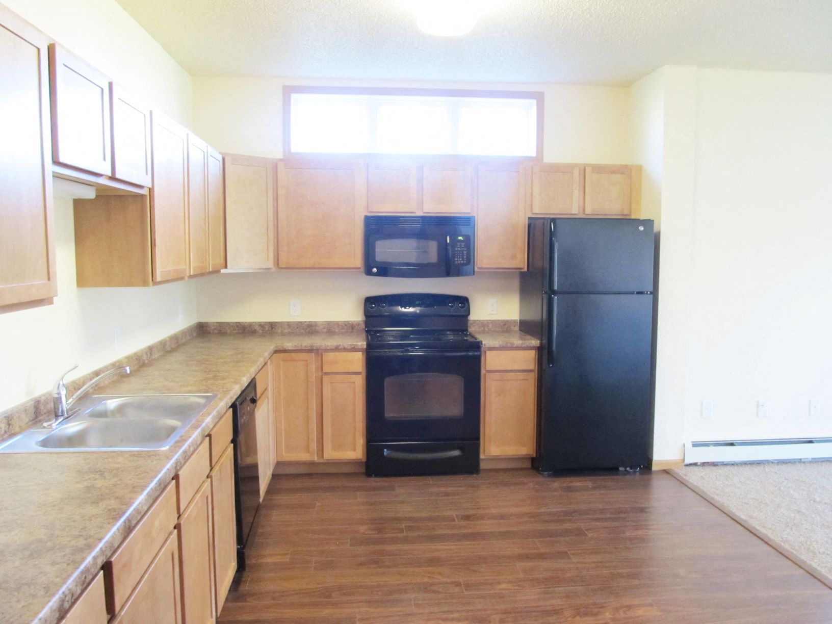 Open kitchen layout with wood flooring at Brandtplace Apartment Homes in Fargo, North Dakota