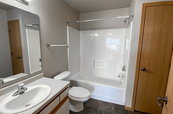 Bathroom in Osgood Townsite, Fargo ND with toilet, closet, full shower, and sink
