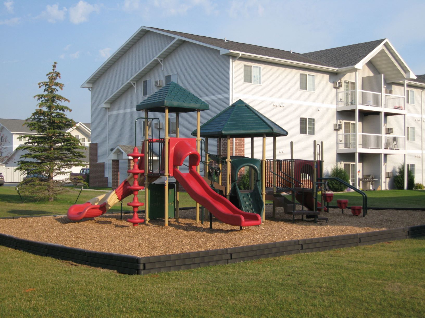 Colorful playground with slides and wood chips at Osgood Townsite in Fargo ND