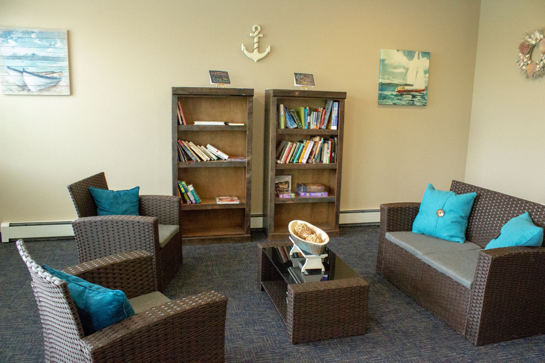 Community room at South Beach apartments in Bemidji, Minnesota with bookshelves and furniture.