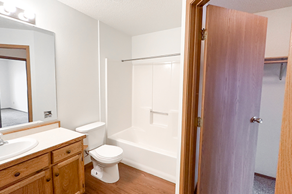a bathroom with a toilet and a sink and a shower