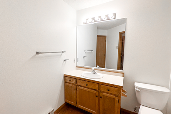 a bathroom with a sink toilet and a mirror