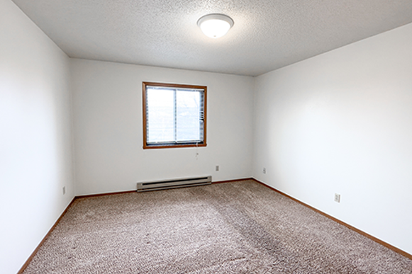 the living room of an empty house with a window