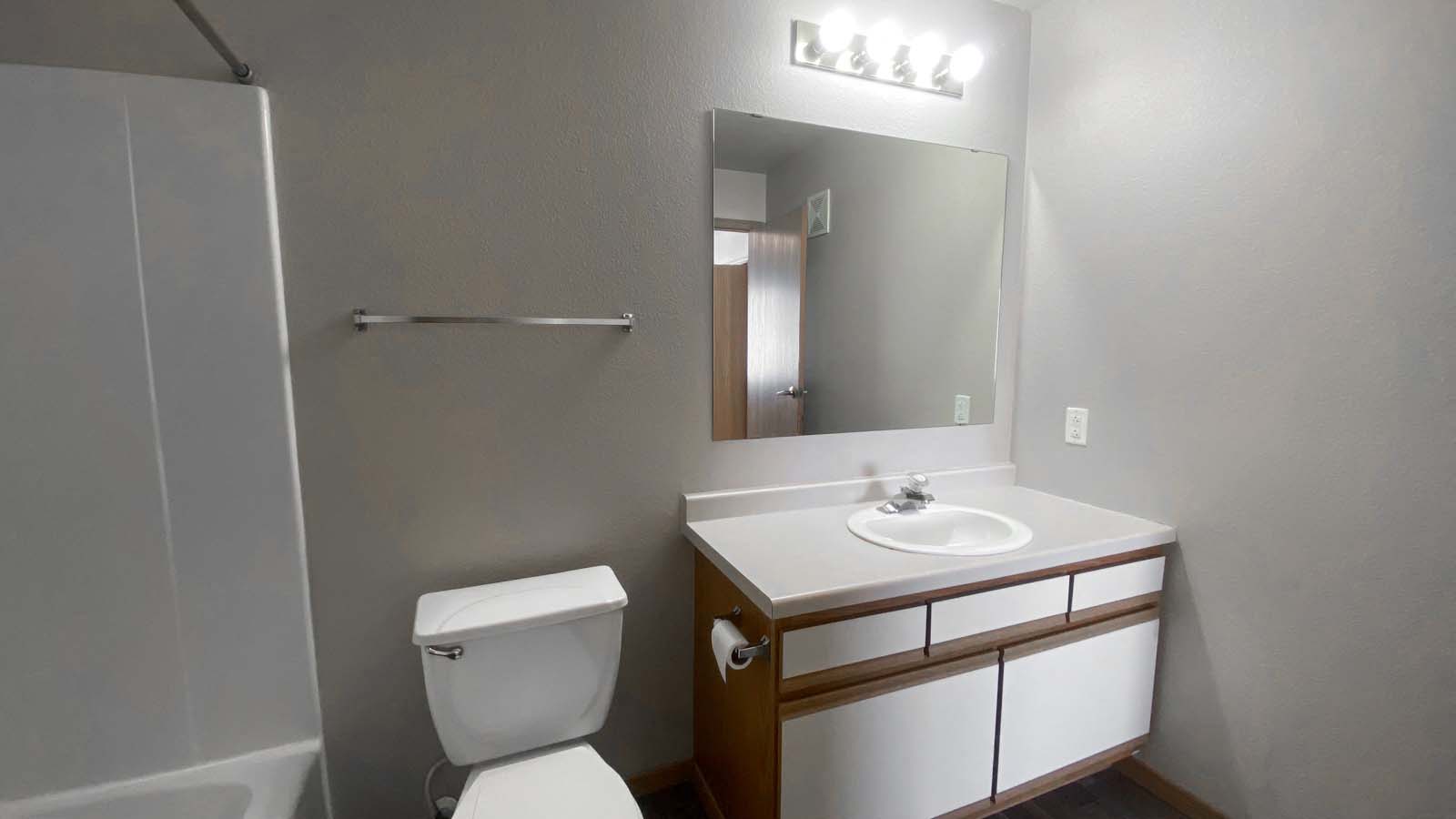 Full bathroom at Amber Fields with full shower and mirror