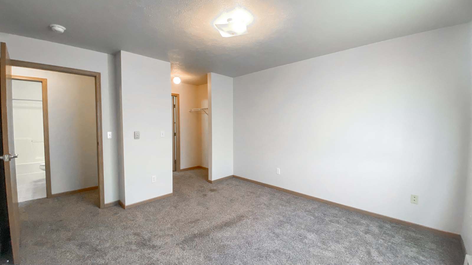Master bedroom at Amber Fields in Fargo ND with walk-through closet and view of the bathroom