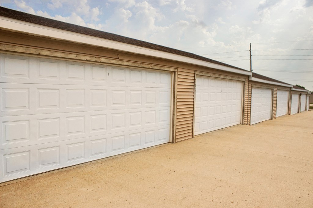 a row of garages with white garage doors