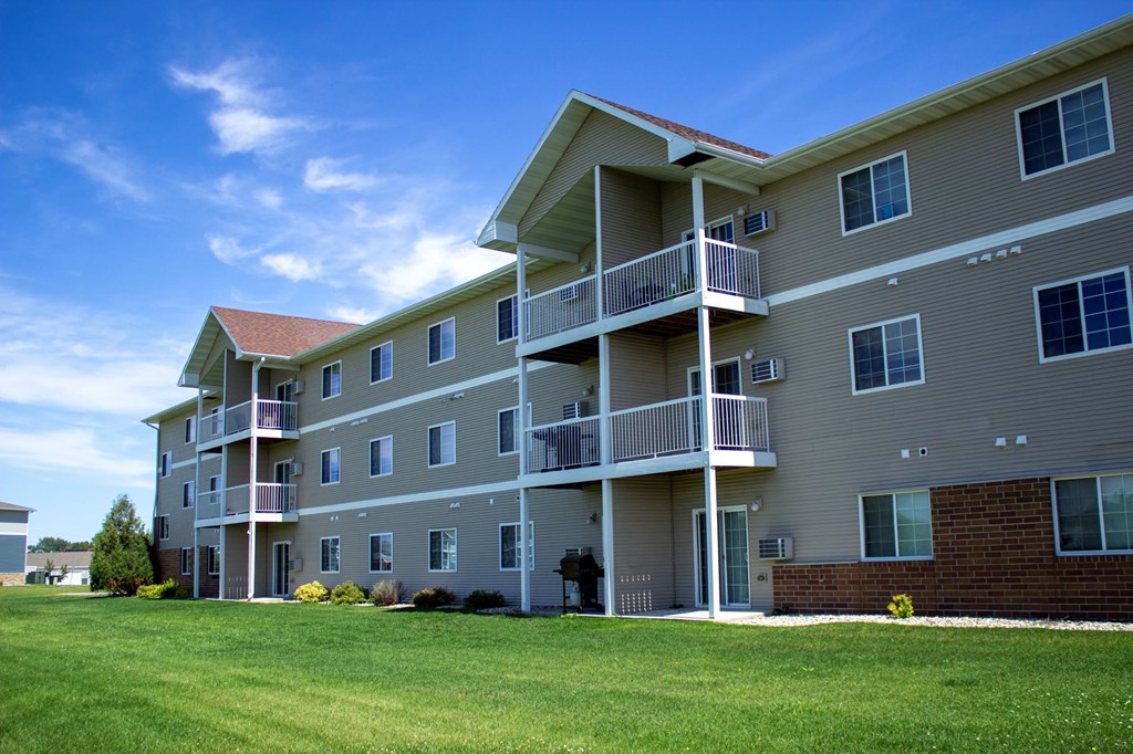 a large apartment building with balconies on a sunny day