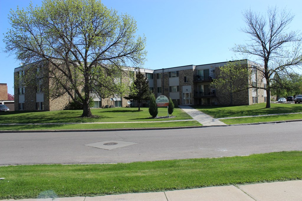 the view of an apartment building from the street