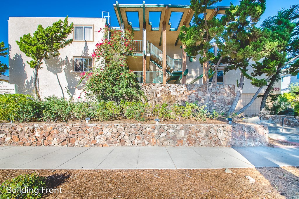 a stone retaining wall in front of a house