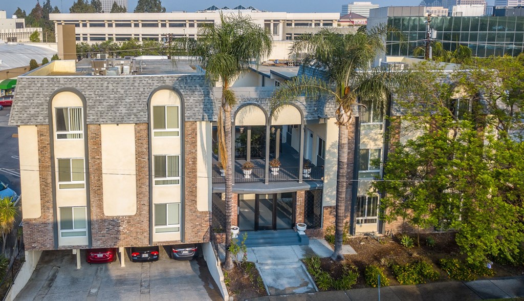 A building with a red car parked in front.