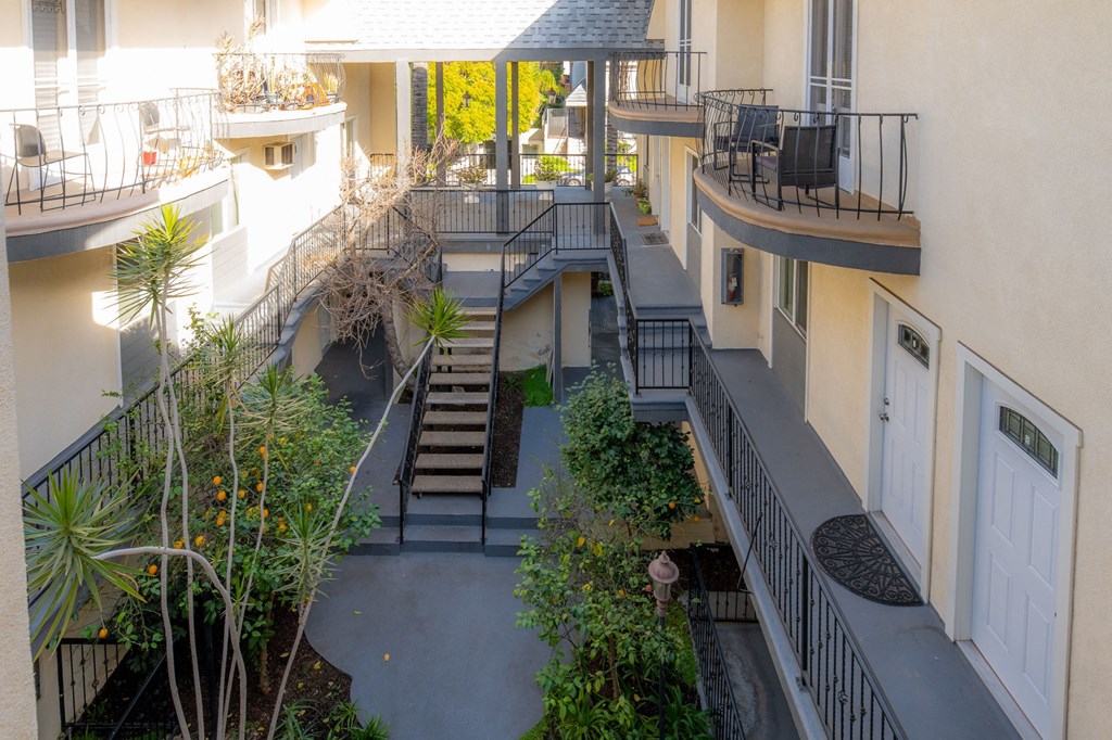 A balcony with a staircase in the middle of it.