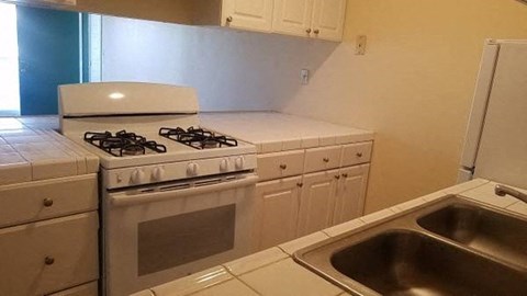 a kitchen with a stove and a sink