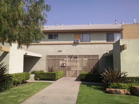 A house with a brown gate in front of it.