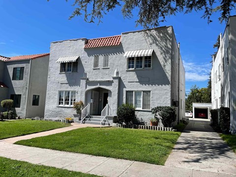 A house with a red tile roof and white walls.