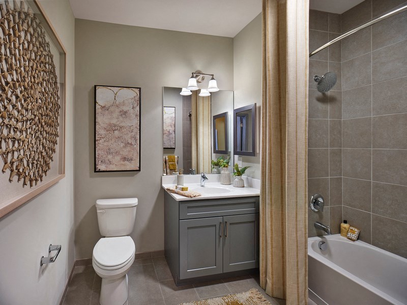 a bathroom with a toilet sink and tub and a shower