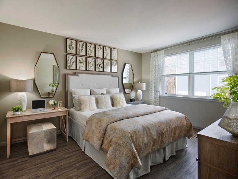 a bedroom with a bed and a desk and a window