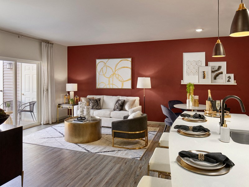 a living room with a red accent wall and a white couch