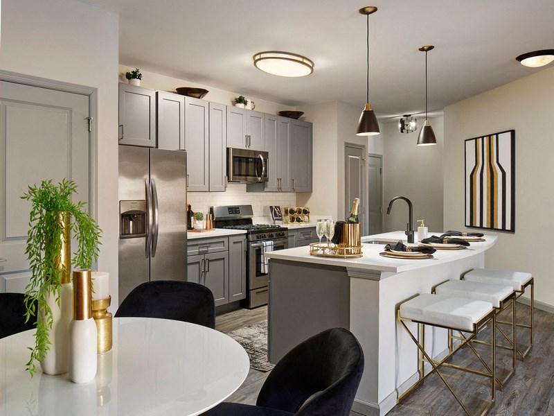 a kitchen with stainless steel appliances and a white table