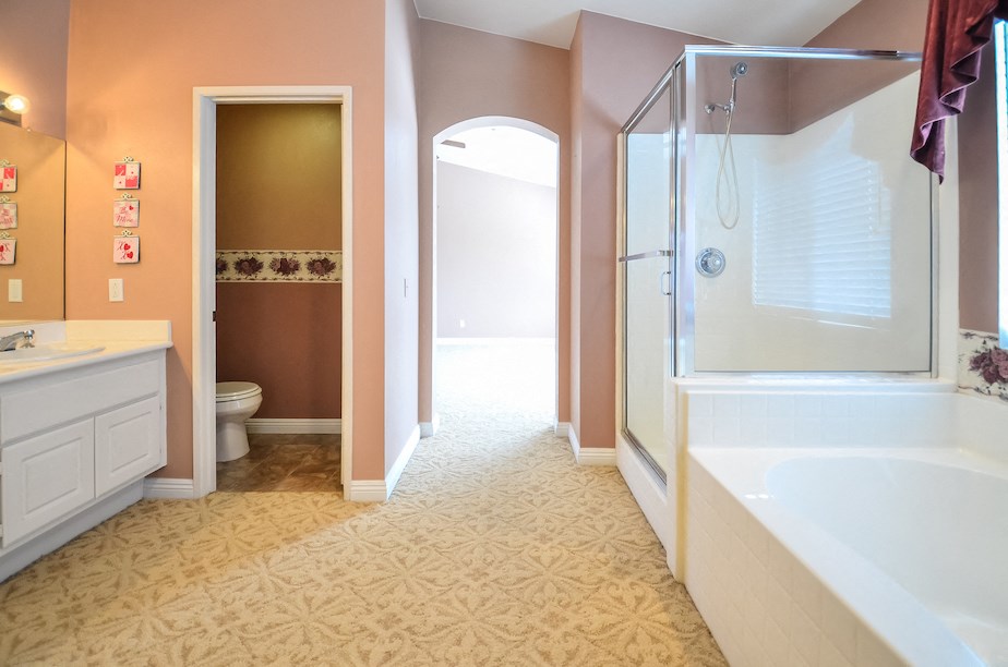 a bathroom with a tub and a shower and a sink