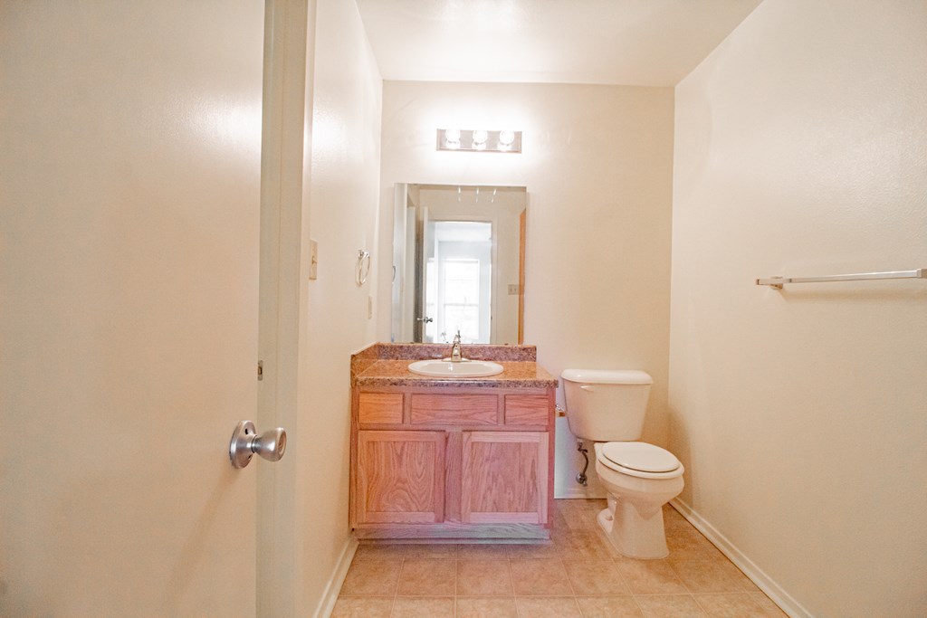a bathroom with a toilet and a sink and a mirror
