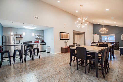 a kitchen and dining room with a table and chairs