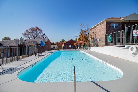 our apartments have a large pool with a building in the background