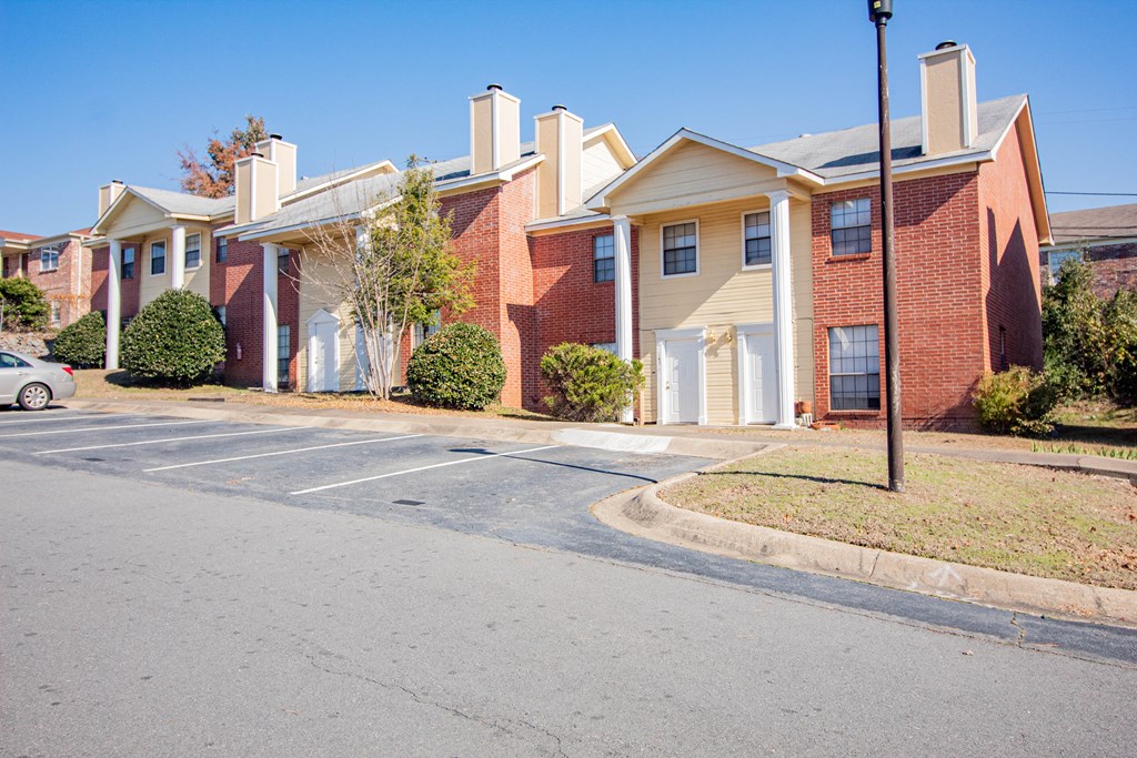 an empty parking lot in front of an apartment building