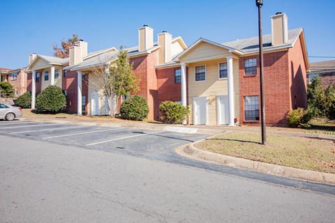 an empty parking lot in front of an apartment building
