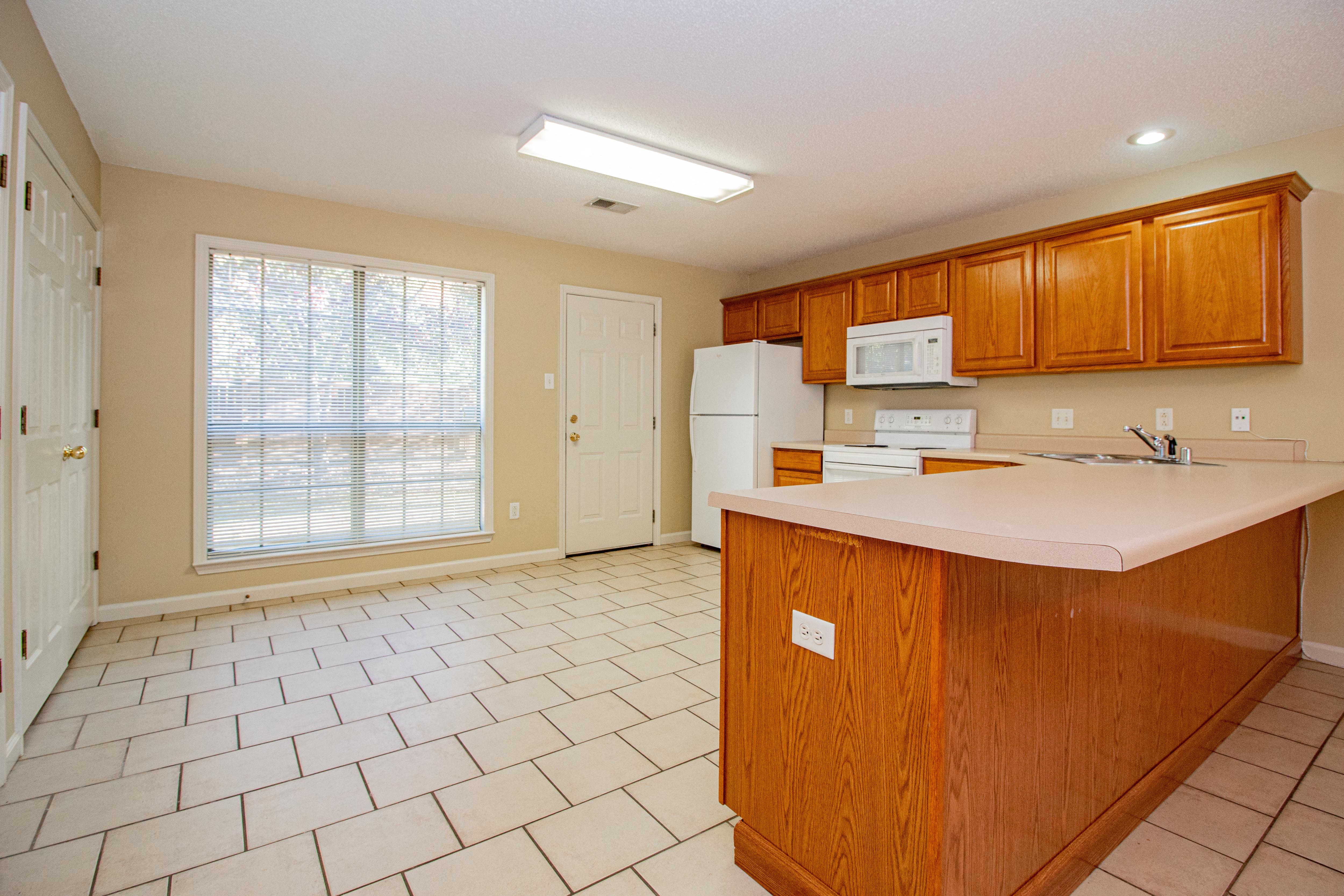 a kitchen with a large window and a counter top