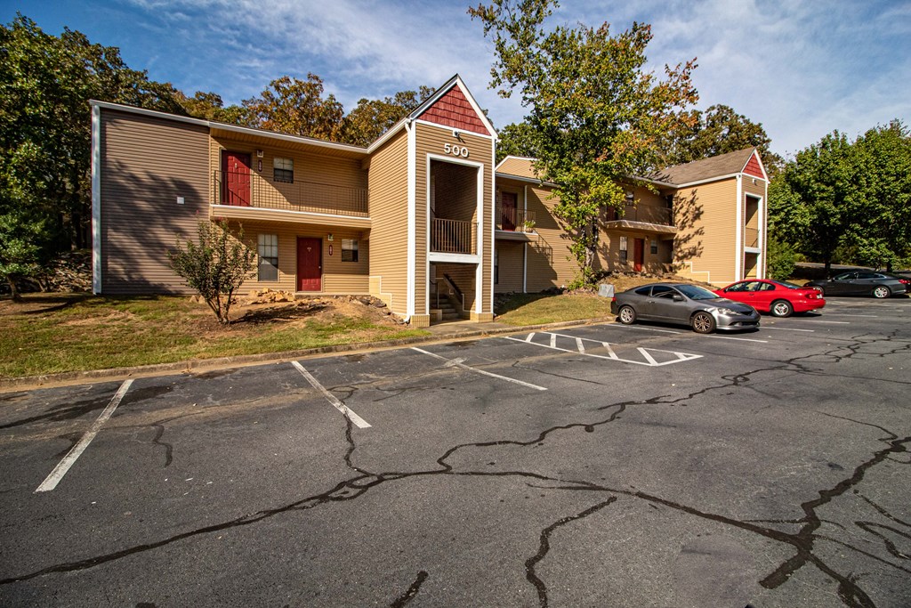 an empty parking lot in front of an apartment building