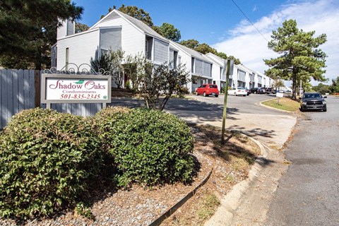 a row of houses with a sign in front