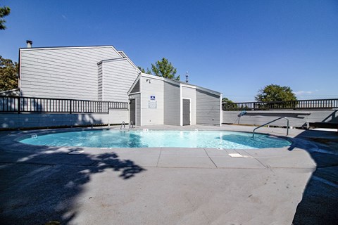 a swimming pool with a building in the background