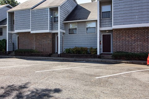 an empty parking lot in front of a house