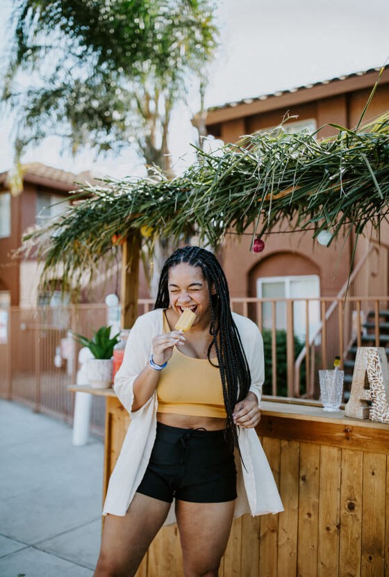 a woman smoking a cigarette in front of a building