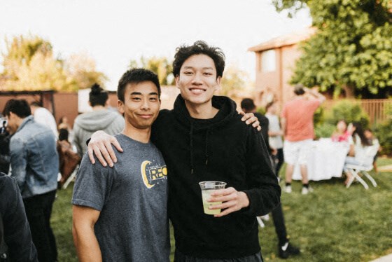 two young men posing for a picture at a party