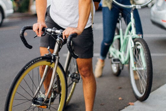 a man riding a bike down a street