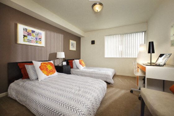 a hotel room with two beds and a desk