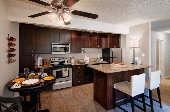 a large kitchen with a island and a dining table