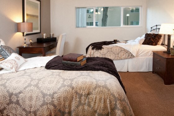 a hotel room with two beds and a window