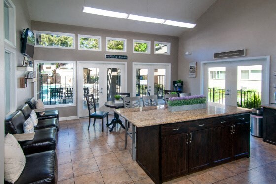 a kitchen and living room with a table and chairs