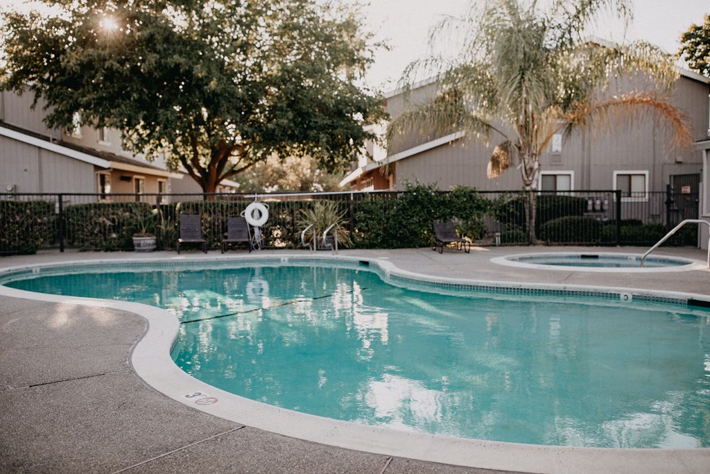 a swimming pool with a house in the background