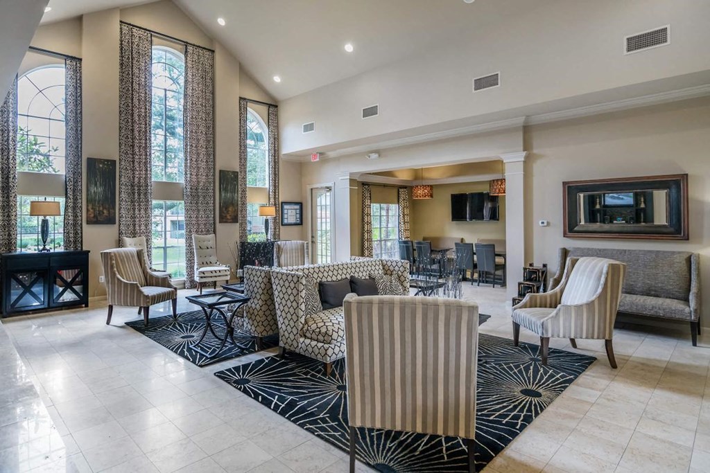 a living room with a couch and chairs and a fireplace