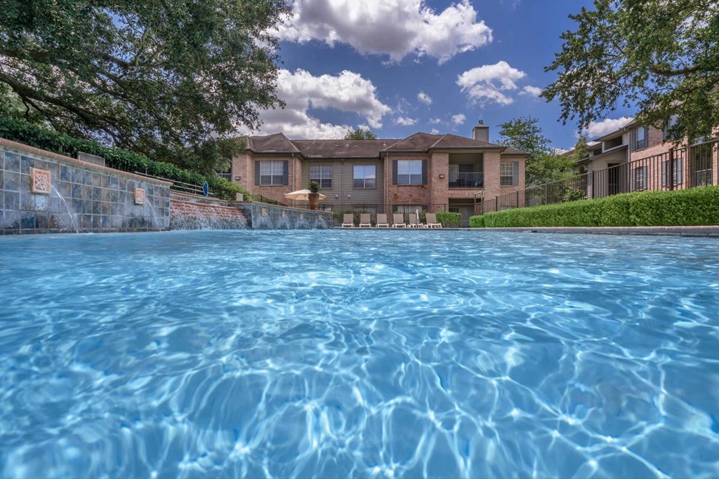 a large swimming pool with a building in the background