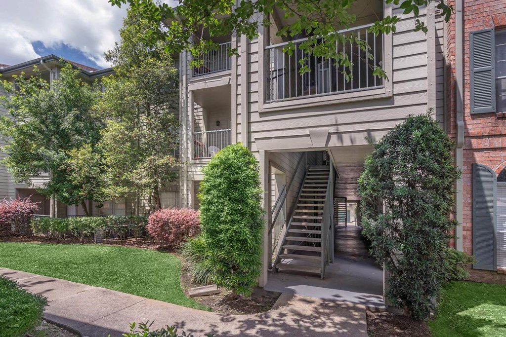 an exterior view of an apartment building with stairs