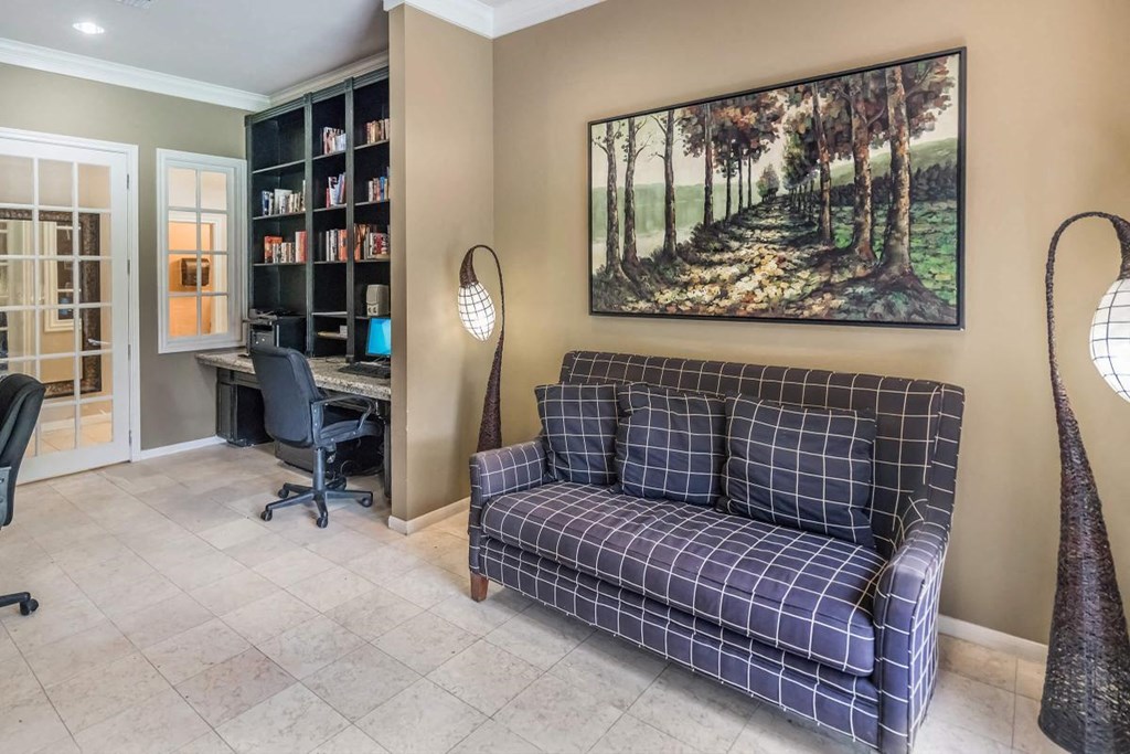 a living room with a couch and a desk