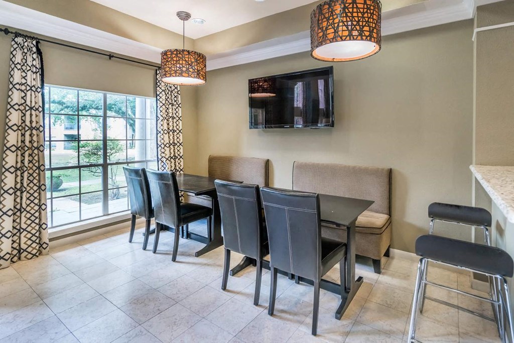 a dining room with a table and chairs and a tv