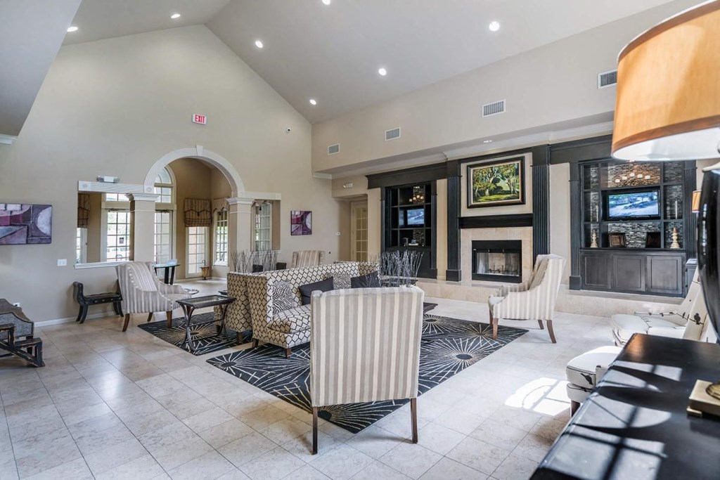 a living room with a table and chairs and a fireplace